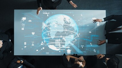 Top down aerial of business team brainstorm idea about digital communication or global network connection. Group of diverse business people discuss about data processing at meeting room. Directorate.