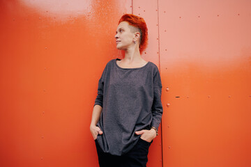 Stylish woman standing near bright garage door