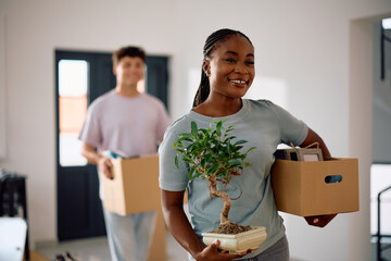 Happy black woman moving into new apartment with her boyfriend.