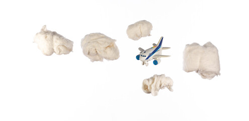 toy airplane flies in cotton wool clouds