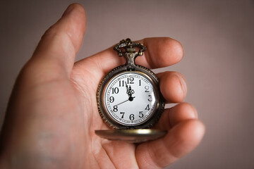 a pocket watch in the hands of a man