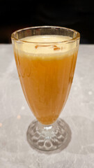 Freshly Squeezed Orange Juice in Elegant Glass on Marble Table with Soft Lighting Background