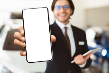 Salesperson Showing Auto Key To Camera Standing In Automobile Rental Office. Copyspace, Selective Focus