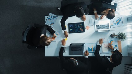 Top down aerial view of manager standing and present marketing plan to skilled investor. Diverse...