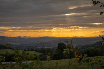Autumn orange sunset with trees and fields near Roprachtice village in mountains