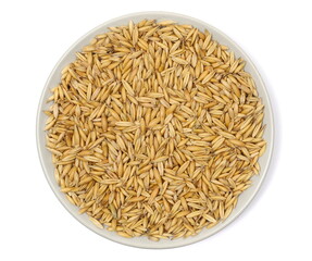 Pile unpeeled oat grains isolated on white, top view