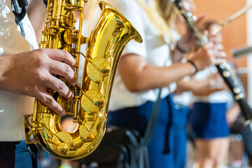 Musician playing the saxophone in a street band on a parade