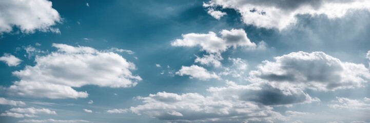Fototapeta premium A serene blue sky filled with fluffy white clouds, creating a peaceful and tranquil atmosphere.