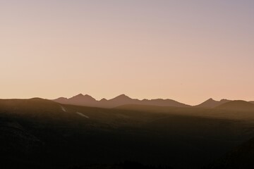 Silhouetted peaks against a vibrant sunset