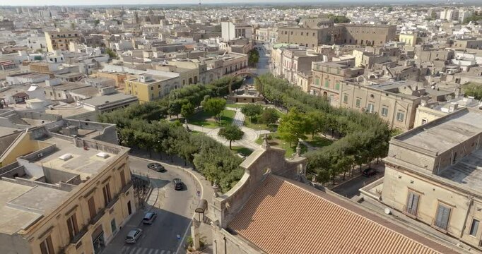 Aerial view of the Manduria municipal villa in the province of Taranto, Italy. In the public park there is a fountain and a war memorial.