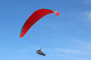 	
Paraglider flying in a blue sky
