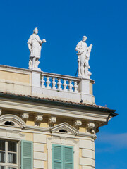 Naklejka premium Two ancient roman statues looking over mantua's historical center