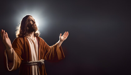 Jesus Christ with his hands raised up in the light praises God © Natalia