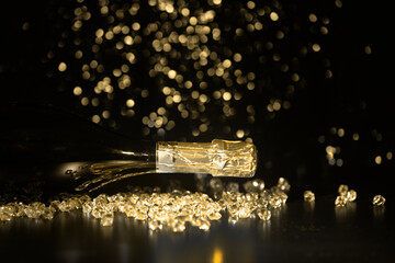 New Year concept, with bright light and champagne bottles, abstract bokeh background