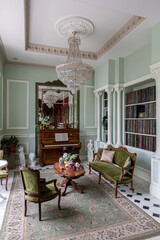 the chic expensive interior of the living room in the historical Baroque style, tiles on the floor, walls decorated with wood. the furniture is in a historical style.
