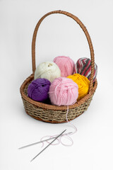 Balls of wool in a basket on a light background. Hobby. Handmade.