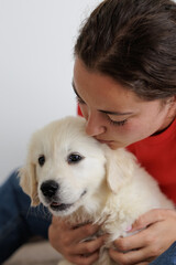 Portrait of a young woman with her golden retriever puppy. Family moments. Sharing time with loved ones. No to animal abandonment. Pets. The dog is man's best friend.