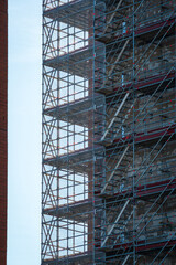 Scaffold sheeting net wrapped apartments building during insulation in england uk