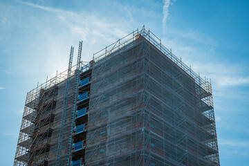 Scaffold sheeting net wrapped apartments building during insulation in england uk