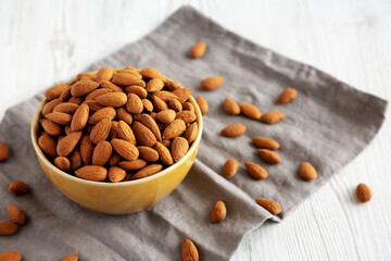 Roasted Organic Almonds in a Bowl, side view. Copy space.