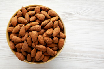Roasted Organic Almonds in a Bowl, top view. Flat lay, overhead, from above. Copy space.