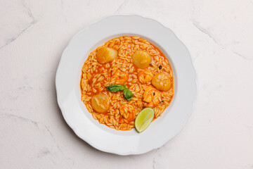Seafood risotto in a large white plate. Menu, banquet, restaurant.