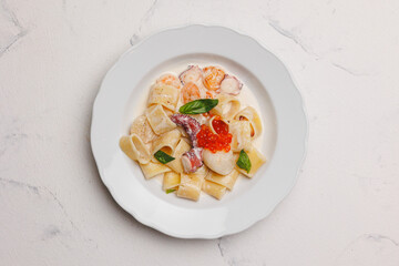 Italian pasta with seafood in a large white plate. Menu, banquet, restaurant.