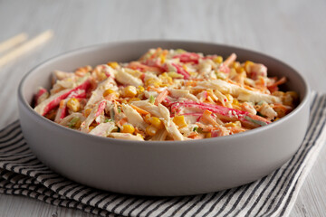 Homemade Japanese Kani Salad with Crab Sticks and Vegetables on a Plate, side view.