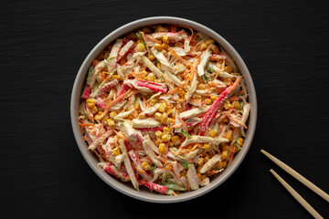 Homemade Japanese Kani Salad with Crab Sticks and Vegetables on a Plate, top view.