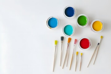 Naklejka premium Colorful paints and brushes on white background