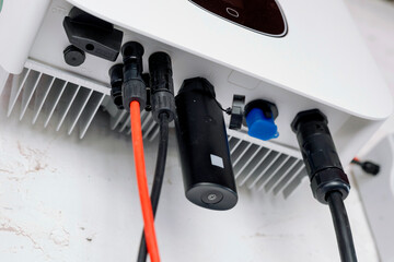 red and black electric wire connected into a residential photovoltaic inverter
