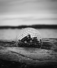 Close up of a disco ball on the beach