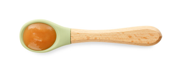 Delicious baby food in spoon isolated on white, top view