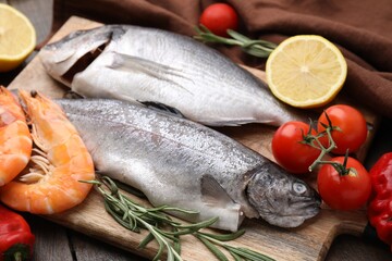 Fresh raw sea food and products on wooden table