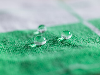 Drops of water laid down on a green cloth
