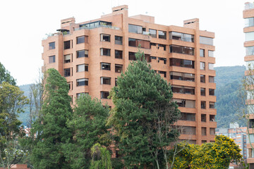 Beautiful modern residential brick deluxe building at north of bogota city with high pines and eastern mountains at background
