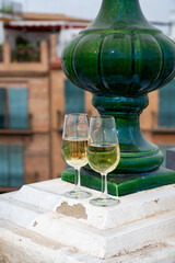 Obraz premium Sherry fino wine tasting on roof of old Triana district in Sevilla with view on Sevilla houses and churches, wine glasses
