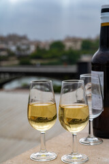 Sherry fino wine tasting on roof of old Triana district in Sevilla with view on Sevilla houses and churches, wine glasses and bottle