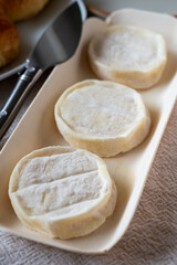 Rocamadour or cabecous soft goat AOC cheese with soft rind produced on farm in Perigord and Quercy on farmers market, departement Lot, France