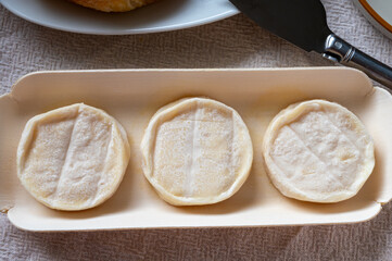 Rocamadour or cabecous soft goat AOC cheese with soft rind produced on farm in Perigord and Quercy on farmers market, departement Lot, France