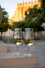Sherry wine glasses and old bogedas jerez wine cellars and church on background in Jerez de la Frontera, wine glasses outdoor, cityview, Andalusia, Spain