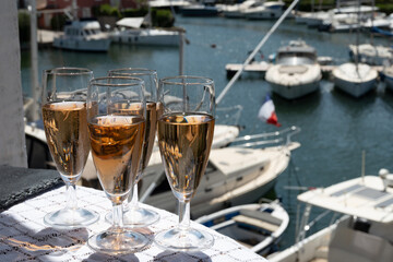 Summer party, French brut rose champagne sparkling wine in flute glasses in yacht harbour of Port Grimaud near Saint-Tropez, French Riviera vacation, Var, France
