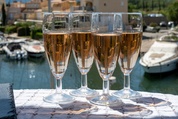 Summer party, French brut rose champagne sparkling wine in flute glasses in yacht harbour of Port Grimaud near Saint-Tropez, French Riviera vacation, Var, France