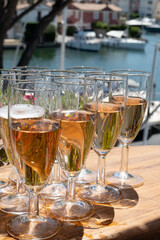 Summer party, French brut rose champagne sparkling wine in flute glasses in yacht harbour of Port Grimaud near Saint-Tropez, French Riviera vacation, Var, France