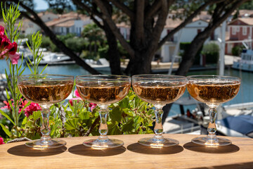 Summer party, French brut rose champagne sparkling wine in coupe glasses in yacht harbour of Port Grimaud near Saint-Tropez, French Riviera vacation, Var, France