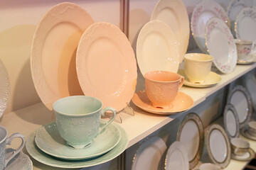 Colorful ceramic dishes and cups on store shelves