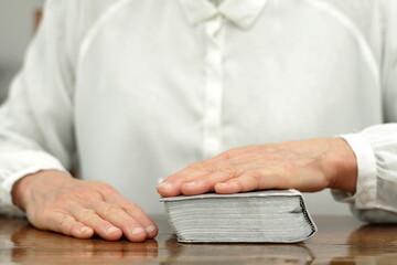 praying with hand on bible learning christianity and the faith of God with people stock image stock photo