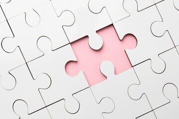 White puzzle with missing piece on pink background, top view