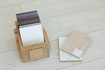 Different samples of wooden flooring in crate indoors