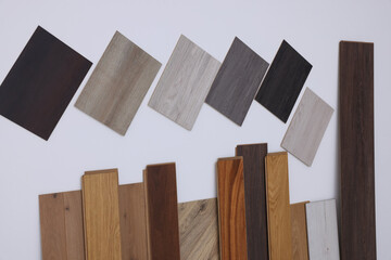 Many different samples of wooden flooring on light background